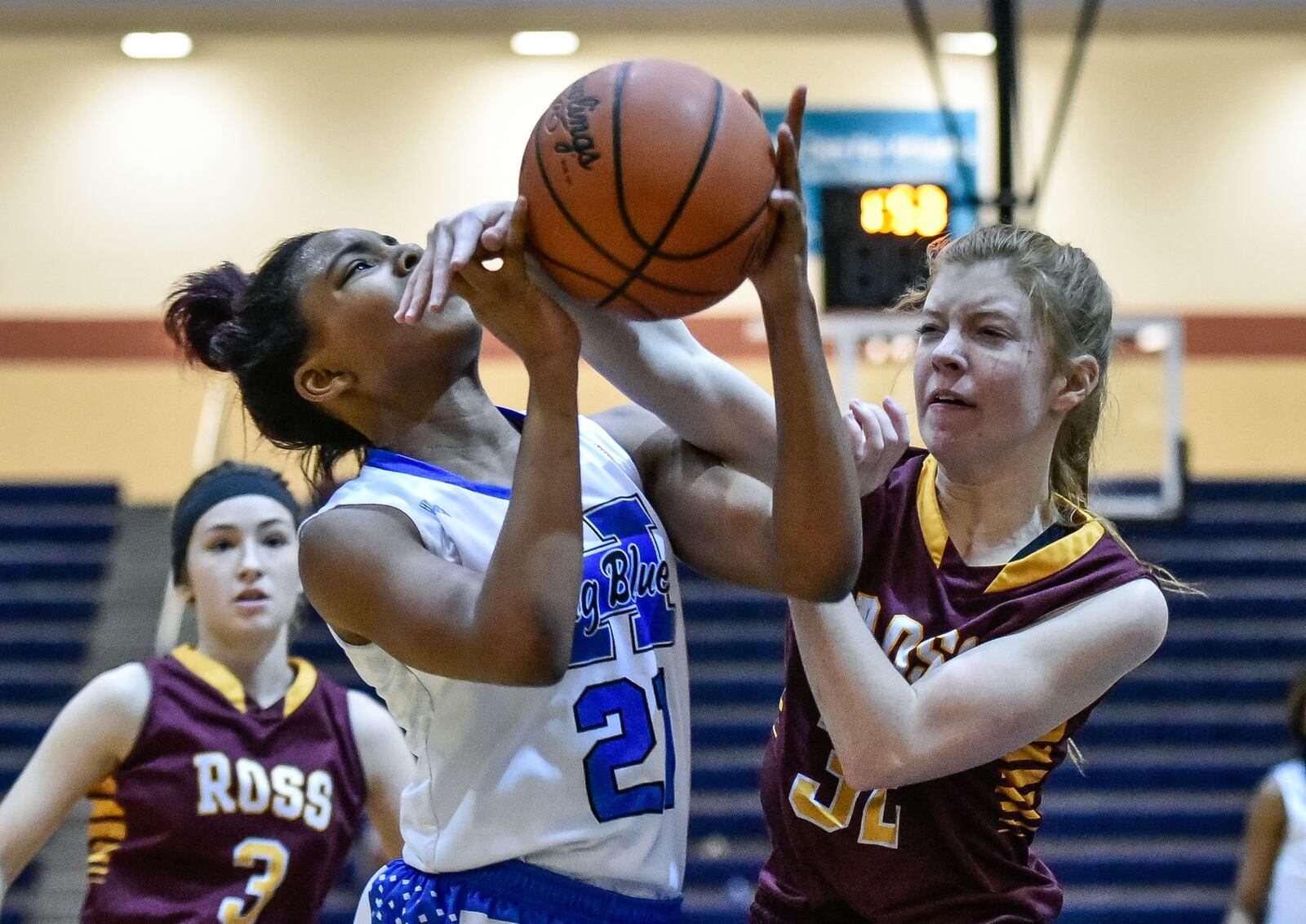 Hamilton’s CiCi Riggins is fouled by Ross’ Grace Stenger during their game Jan. 8, 2018, at the Hamilton Athletic Center. Host Big Blue won 61-43. NICK GRAHAM/STAFF