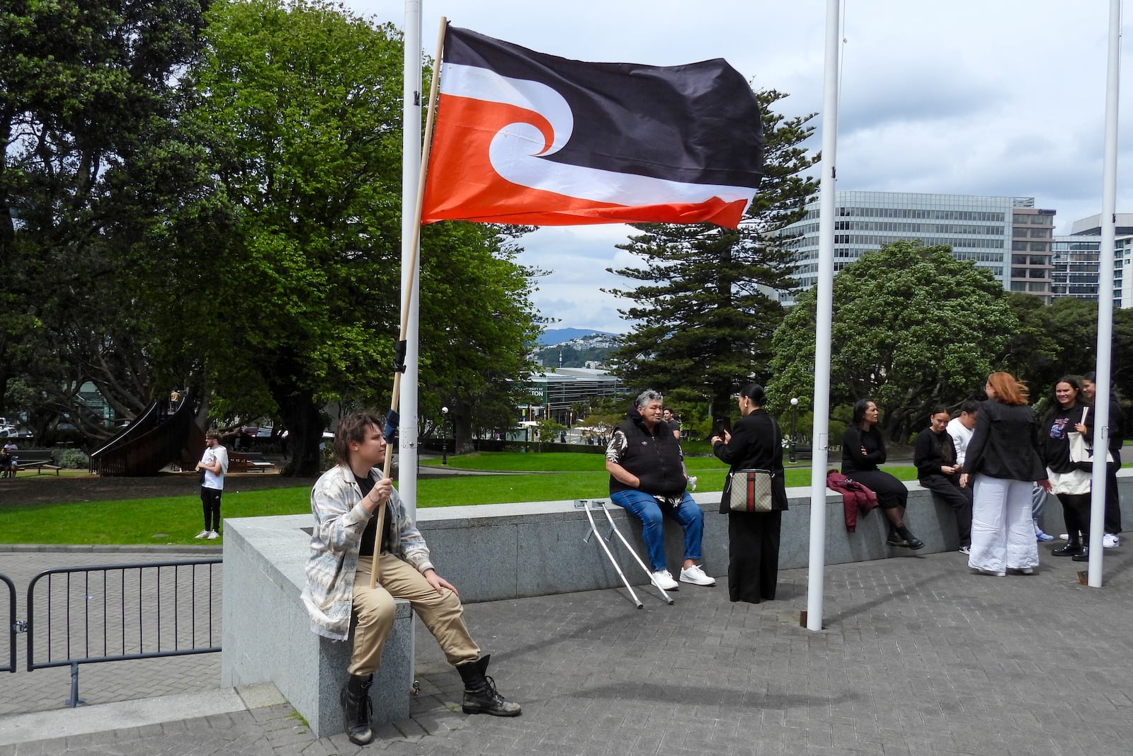 A protester against the Treaty Principal Bill sits outside Parliament in Wellington, New Zealand, Thursday, Nov. 14, 2024. (AP Photo/Charlotte McLay-Graham)