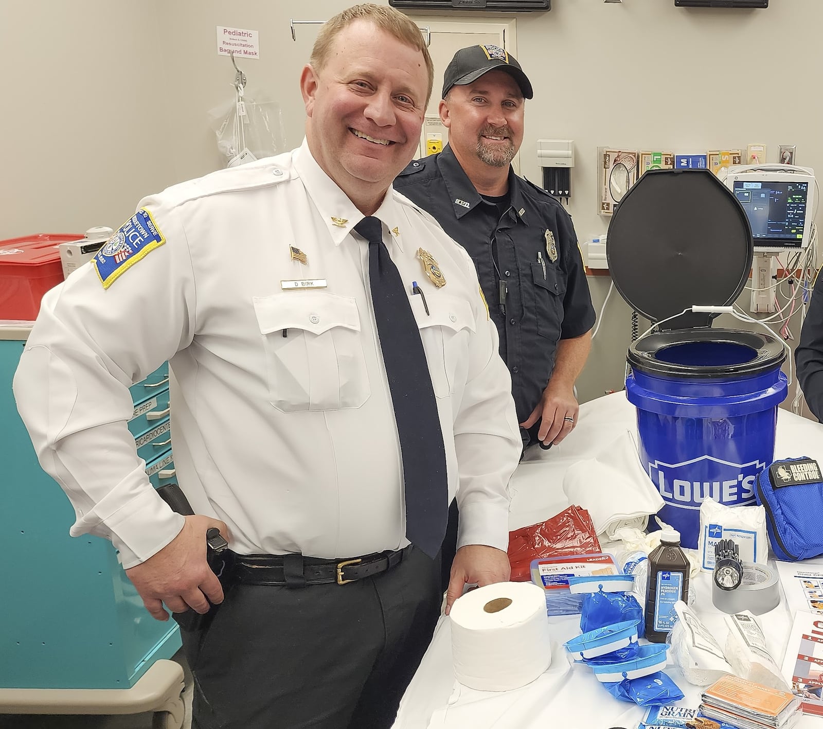 Middletown Division of Police chief David Birk, left, is shown in file photo involving barricade buckets distributed to Middletown school classrooms. Birk has been on paid leave since Dec. 20, 2023. NICK GRAHAM/STAFF