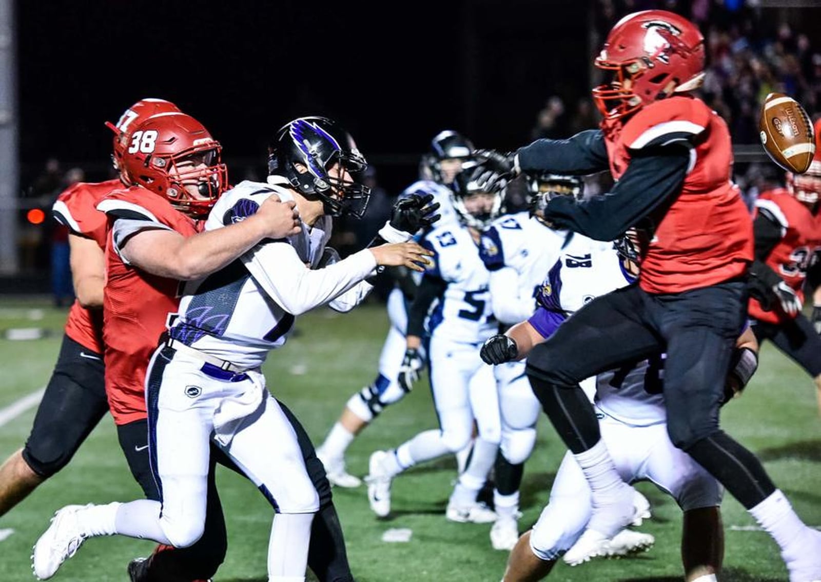 Cincinnati Hills Christian Academy quarterback Danny Vanatsky (7) fumbles under pressure from Madison’s Max Evans (38) and Evan Crim (34, right) during Friday night’s Division V, Region 20 semifinal at Lakota East. NICK GRAHAM/STAFF