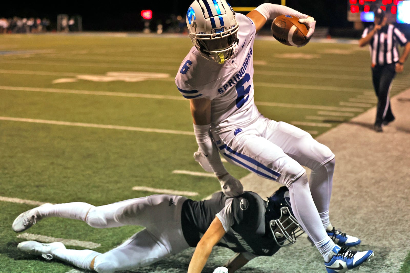 Springboro's Jaxon Long is knocked out of bounds by Fairmont's Kaleb Moore. BILL LACKEY/STAFF