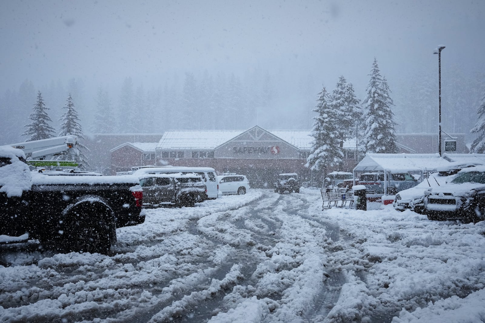 The parking lot to a Safeway supermarket is covered in snow during a storm Thursday, Feb. 13, 2025, in Truckee, Calif. (AP Photo/Brooke Hess-Homeier)