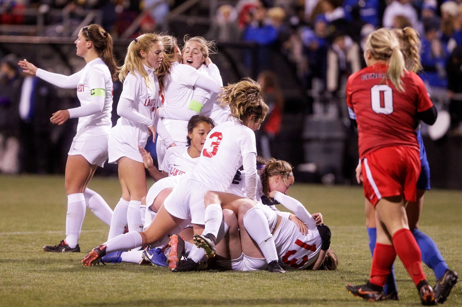 Lakota West’s players pile on Kailyn Dudukovich (13) after she scores a goal with 13 seconds left in the Division I state championship soccer game against Anthony Wayne pn Saturday, Nov. 9, 2019 at MAPFRE Stadium in Columbus. Lakota West won 2-1. NICK GRAHAM/STAFF