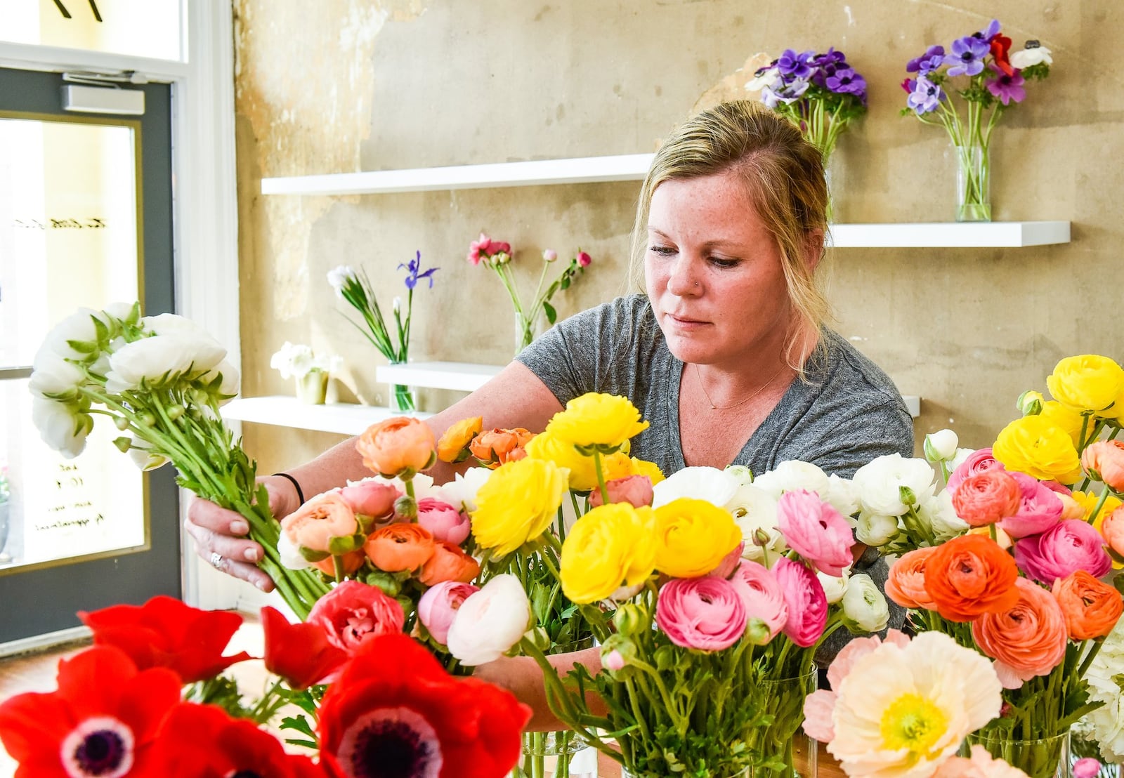 Mindy Staton prepares arrangements at Two Little Buds in Hamilton. The business recently moved from Bridgewater Falls to Hamilton and offers wedding and event arrangements. It specializes in locally grown flowers. 