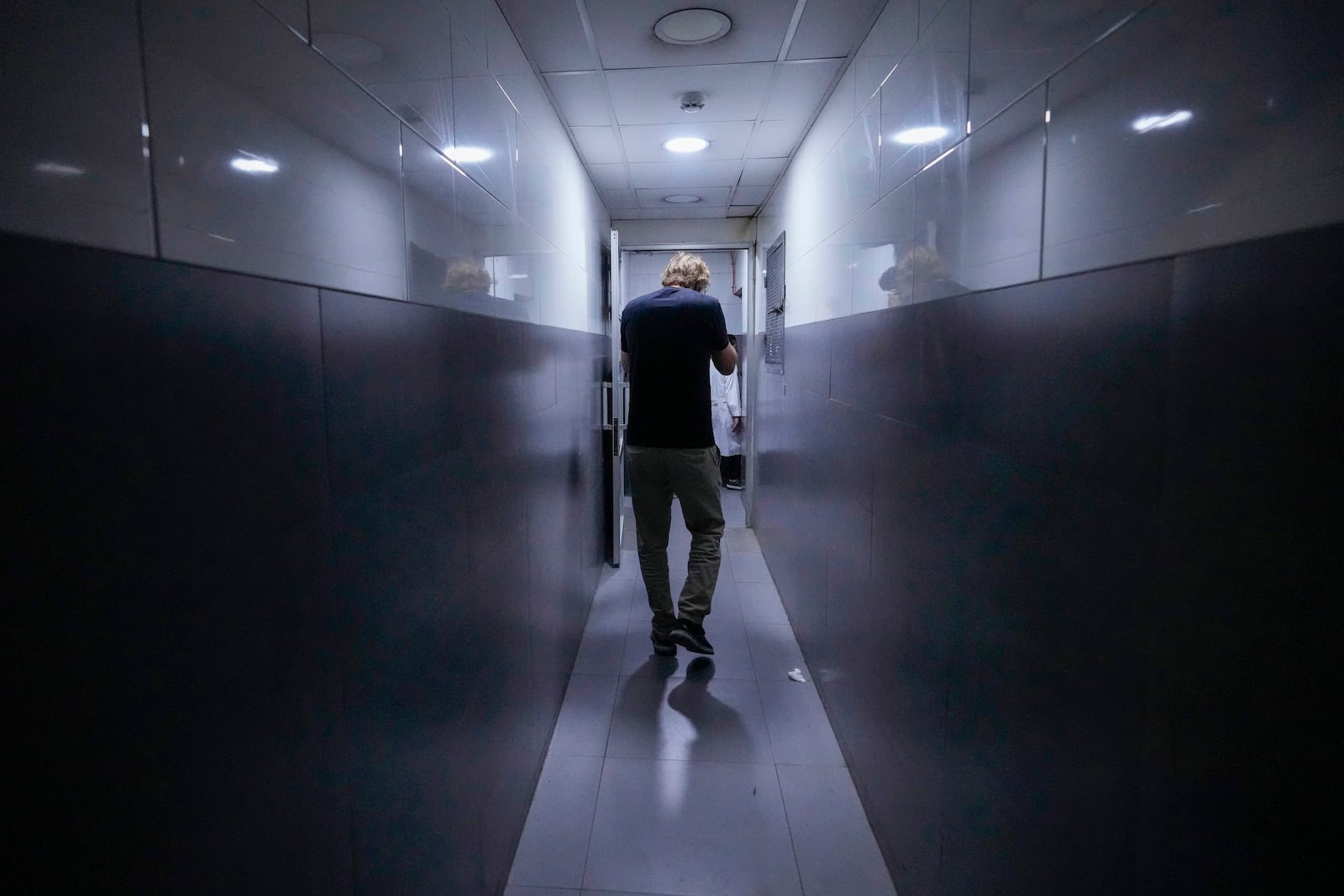 A journalist takes a tour inside Sahel General Hospital, in Dahiyeh, Beirut, Lebanon, Tuesday, Oct. 22, 2024, a day after the Israeli army said that Hezbollah is storing hundreds of millions of dollars in cash and gold under the hospital. (AP Photo/Hassan Ammar)