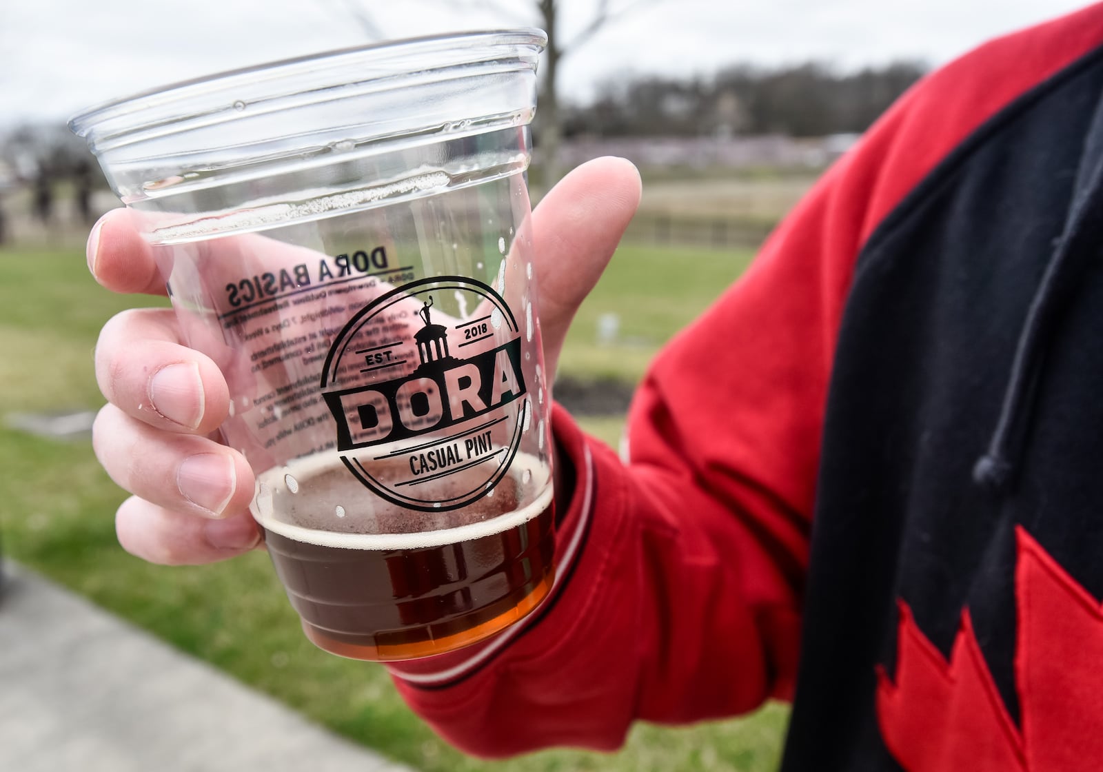 Several people were utilizing the DORA district on St. Patrick's Day with beer from The Casual Pint at Marcum Park March 17, 2020 in Hamilton. Normal St. Patrick's Day festivities were halted with the state ban on gathering in bars and restaurants to help prevent the spread of coronavirus. NICK GRAHAM / STAFF