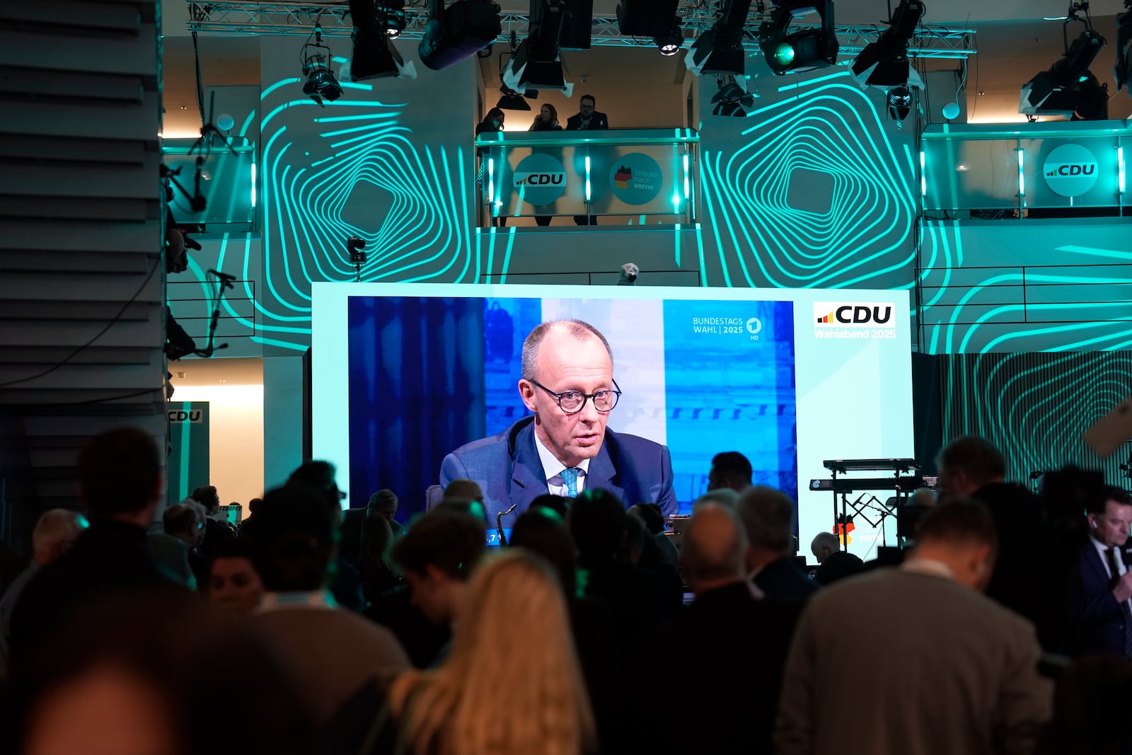 A video screen at the Christian Democratic Union party headquarters shows Friedrich Merz, the candidate of the CDU, taking part in a post-election debate, in Berlin, Germany, Sunday, Feb. 23, 2025. (AP Photo/Markus Schreiber)