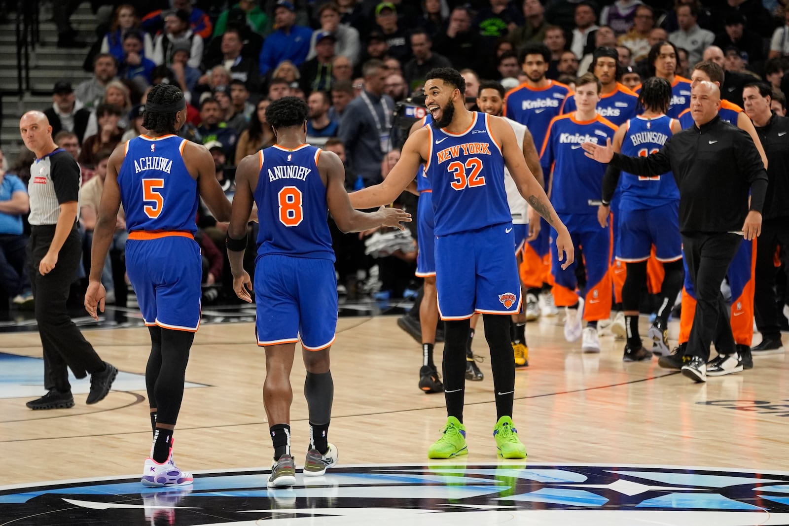 New York Knicks center Karl-Anthony Towns (32) celebrates with teammates after a timeout called in the second half of an NBA basketball game against the Minnesota Timberwolves, Thursday, Dec. 19, 2024, in Minneapolis. (AP Photo/Abbie Parr)