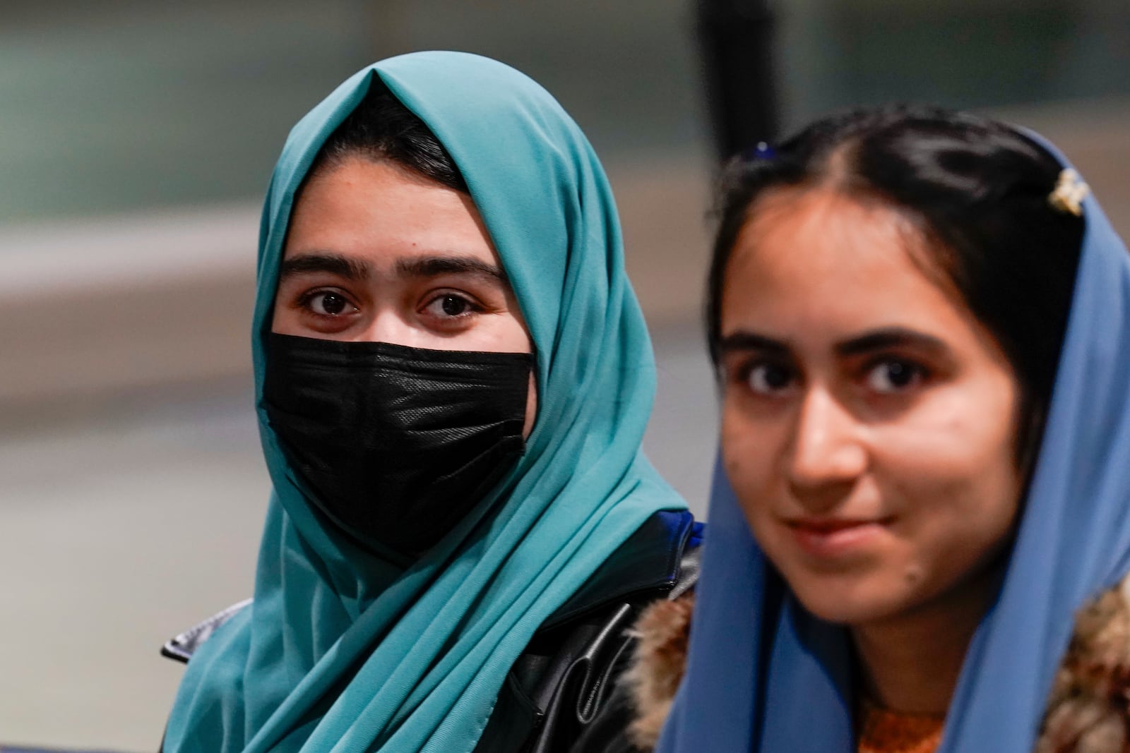 Afghan sisters Nilaap Osmani, left, and Mursal Omani, wait to the leave the Sacramento International Airport for their new home in Northern California Tuesday, March 11, 2025. (AP Photo/Rich Pedroncelli)