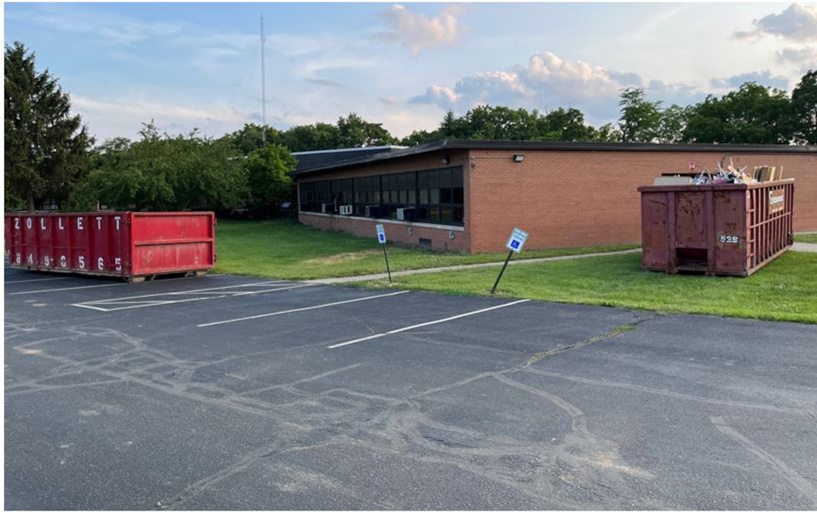 Large Dumpsters have been placed around the Hampton Bennett School Building as crews clear out the building as well as perform asbestos abatement prior to the building's demolition. The 68-year-old building served as a middle and junior high school in the 1950s and 1960s. It also served as the Franklin City Schools central administrative offices, special and gifted education, a Kindergarten and Pre-K Early Childhood Center. The building will be razed for a  parking lot for the new Franklin High School next door. ED RICHTER/STAFF