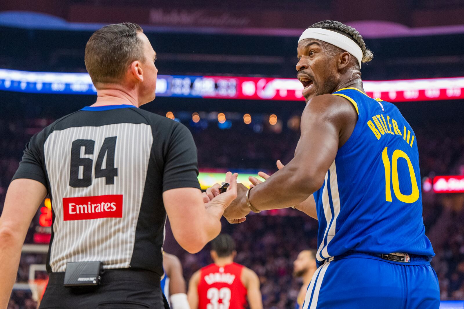 Golden State Warriors forward Jimmy Butler III (10) argues with the referee (64) during the first half of an NBA basketball game against the Portland Trail Blazers in San Francisco, Monday, March 10, 2025. (AP Photo/Nic Coury)