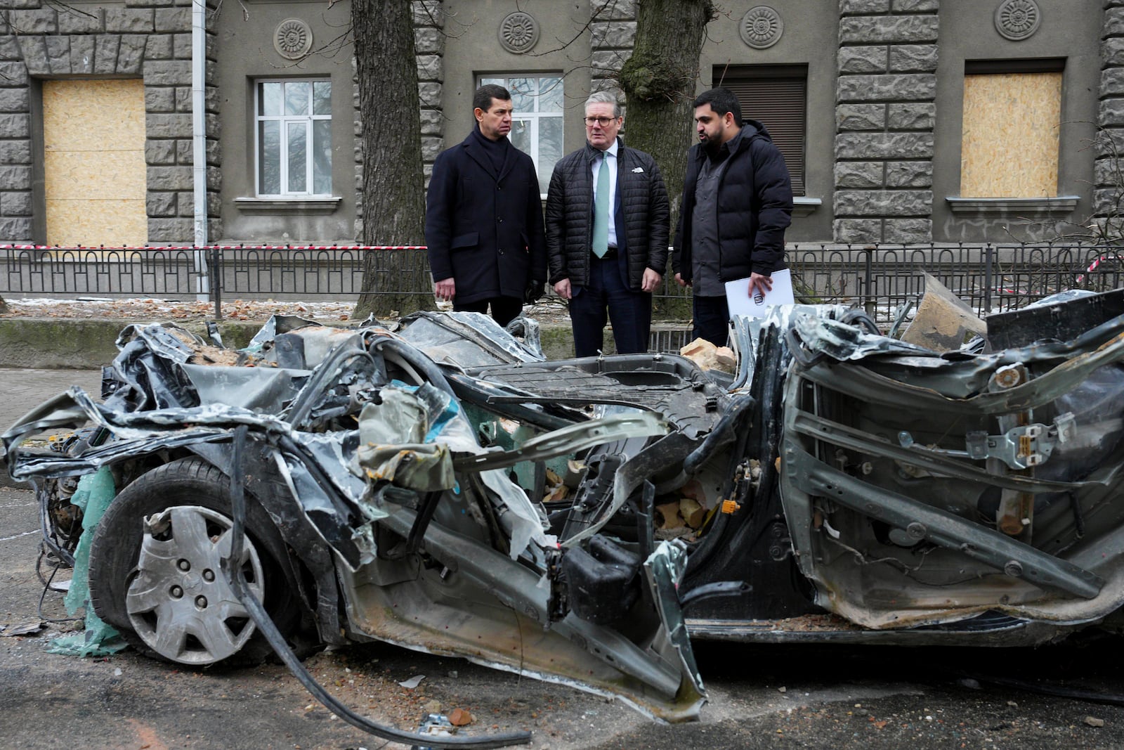 British Prime Minister Keir Starmer is guided by Ukrainian officials as he inspects a damaged vehicle along a street, in Kyiv, Ukraine Thursday, Jan. 16, 2025. (Carl Court/Pool Photo via AP)