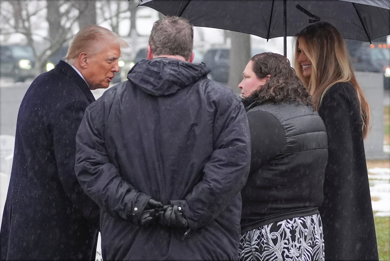 President-elect Donald Trump and Melina Trump talks with family members in Section 60 at Arlington National Cemetery, Sunday, Jan. 19, 2025, in Arlington, Va. (AP Photo/Evan Vucci)