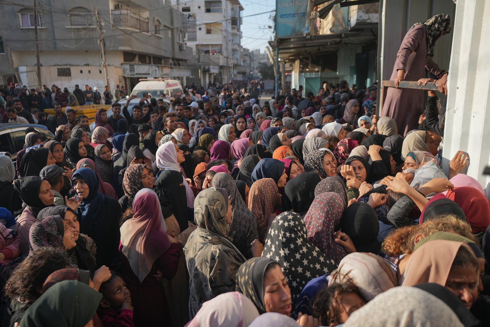 Residents gather in front of a bakery to get their share of bread in Deir al-Balah, Gaza Strip, Thursday, Nov. 21, 2024. (AP Photo/Abdel Kareem Hana)