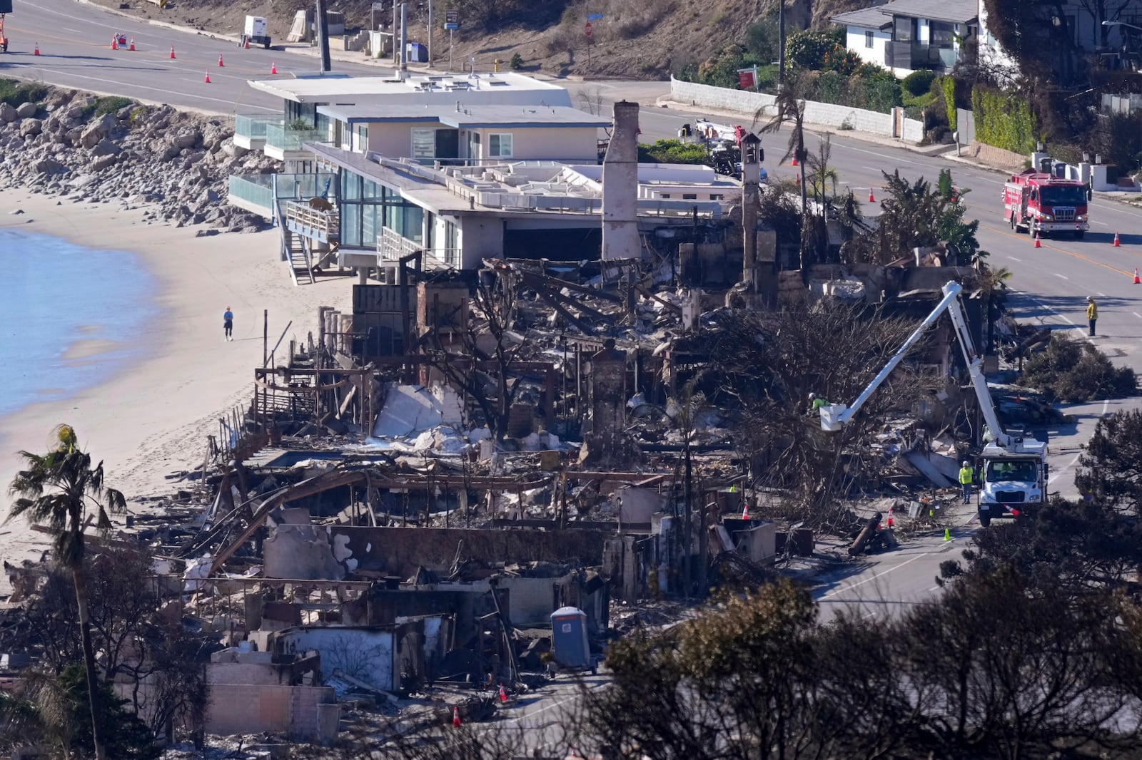 FILE - Homes along Pacific Coast Highway are seen burned and damaged while a few still stand after the Palisades Fire, Jan. 12, 2025, in Malibu, Calif. (AP Photo/Mark J. Terrill, File)