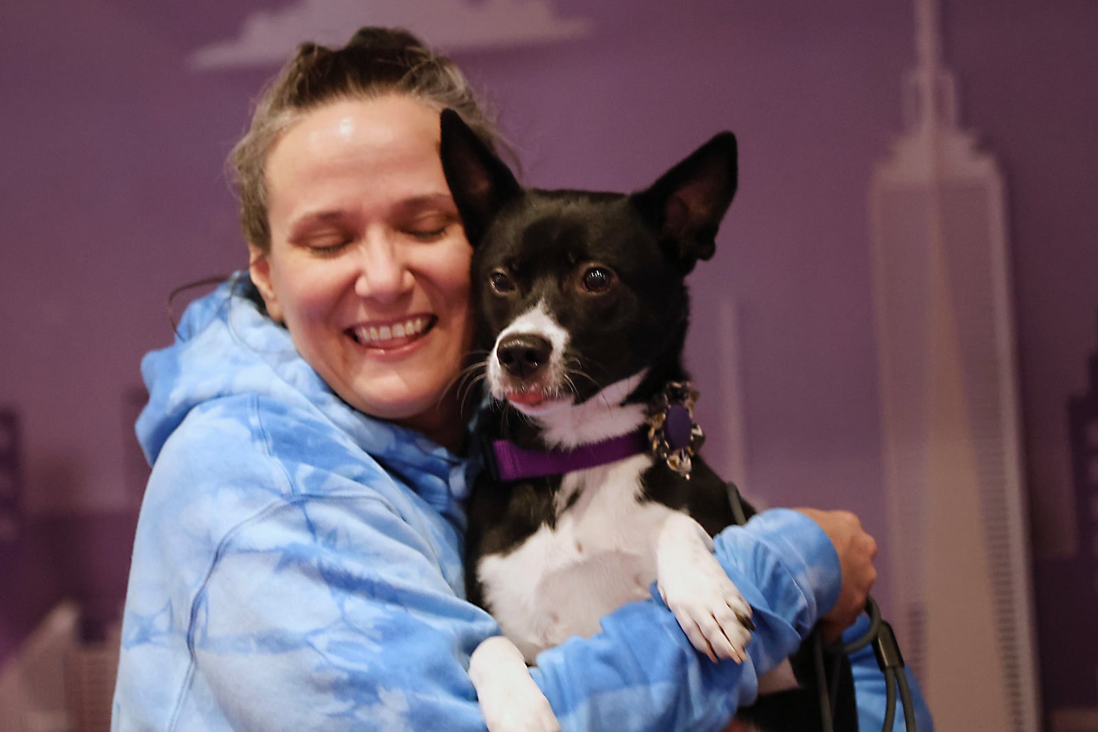 Katrina Wallace poses for a photo with her mixed breed, Beatrice, at the 149th Westminster Kennel Club Dog show, Saturday, Feb. 8, 2025, in New York. (AP Photo/Heather Khalifa)