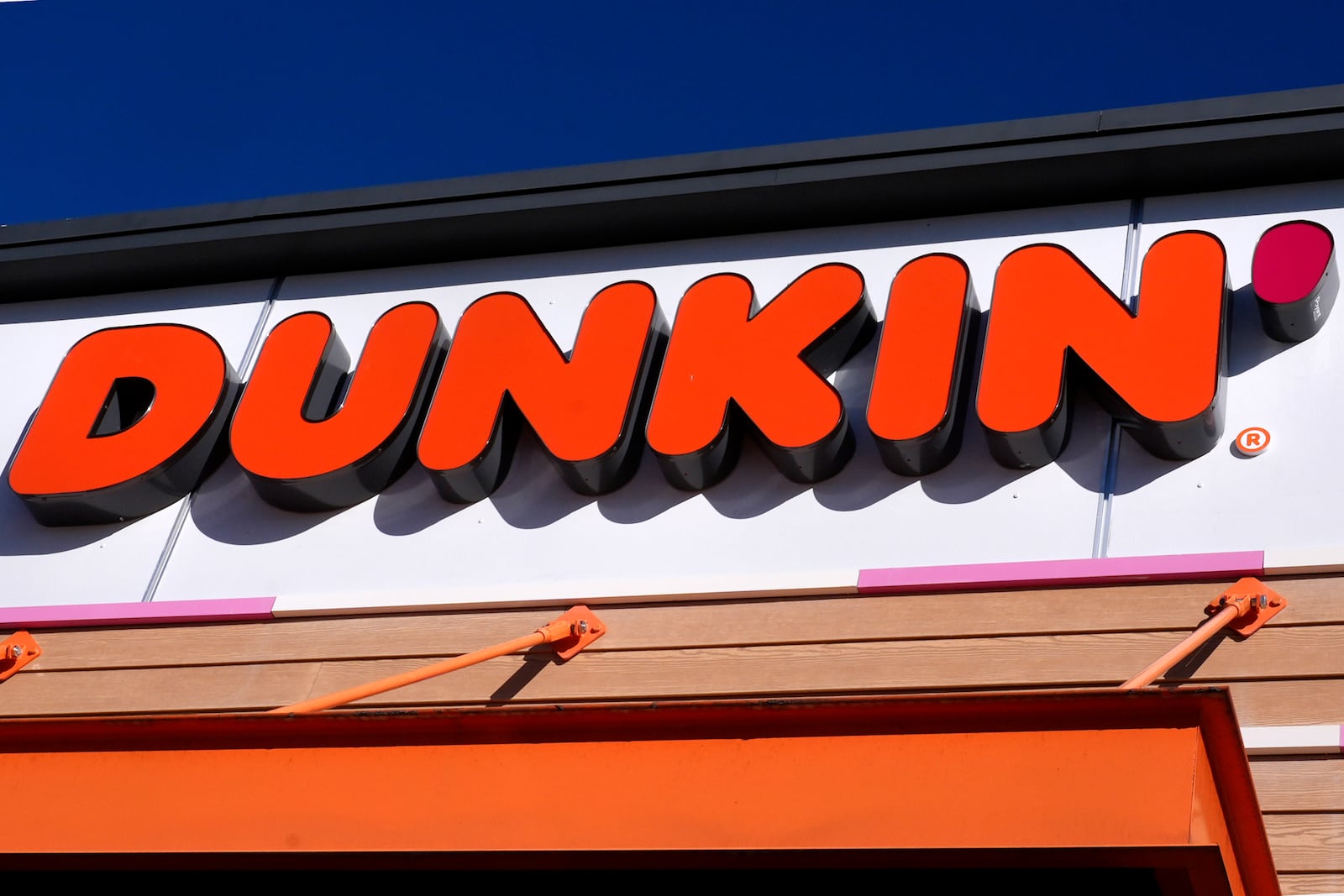 The Dunkin' name appears on a sign over the doorway at a Dunkin' donuts location, Friday, Jan. 10, 2025, in Derry, N.H. (AP Photo/Charles Krupa)