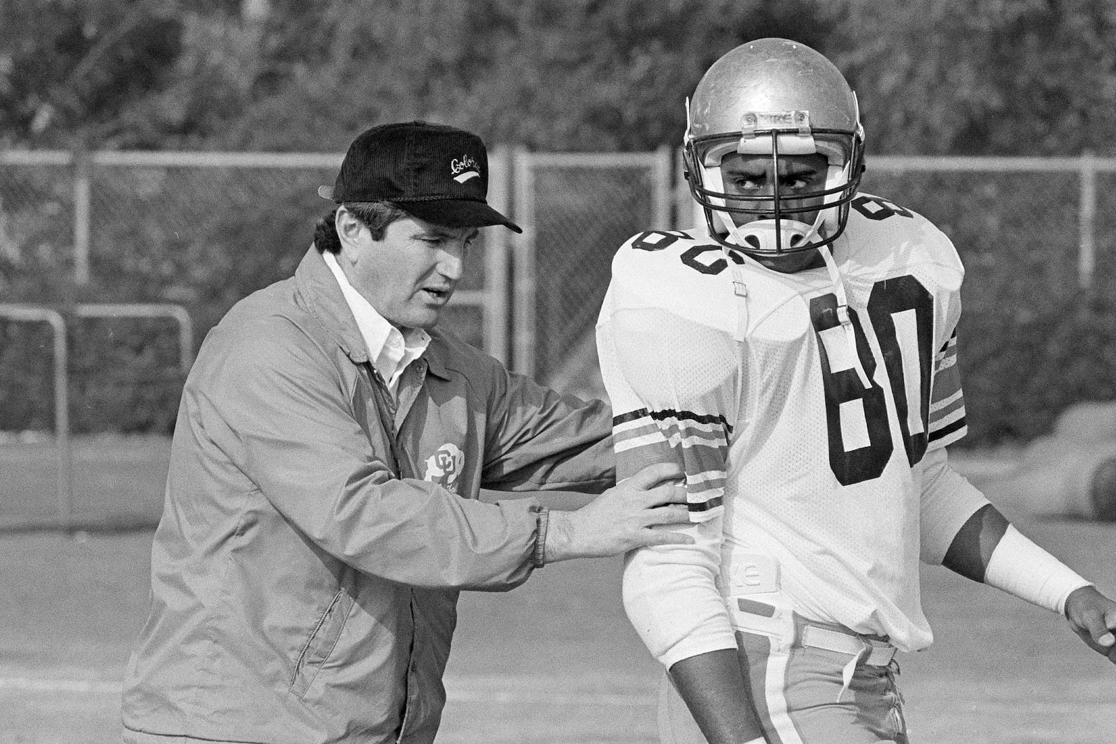 FILE - Colorado University head coach Bill McCartney repositions tight end Jon Embree (80) during practice in Irvine, Calif., Dec. 26, 1985. (AP Photo/Doug Pizac, File)