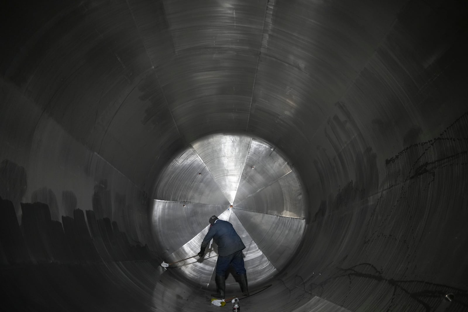 An employee cleans a container at a steel tank factory in Mexico City, Tuesday, Feb. 11, 2025. (AP Photo/Eduardo Verdugo)