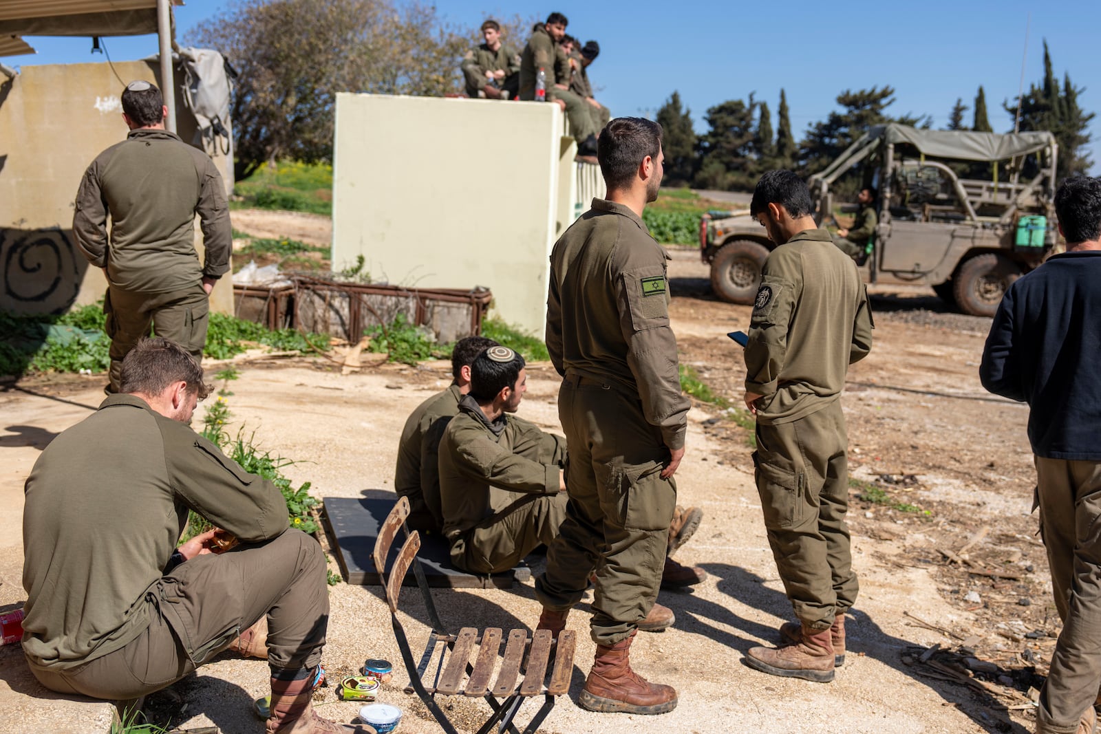 Israeli soldiers gather in northern Israel after Israeli forces withdrew from border villages in southern Lebanon ,Tuesday, Feb. 18, 2025. (AP Photo/Ariel Schalit)