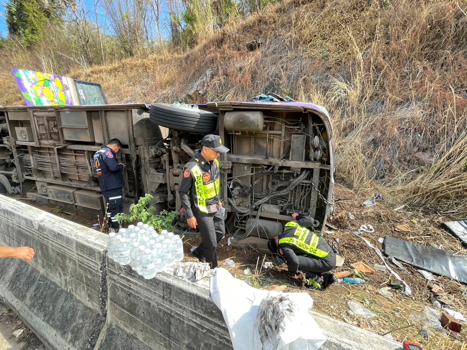 Investigators inspect accident site where a bus travelling from northern Thailand overturned in eastern Prachinburi province, killing multiple people on Wednesday Feb 26, 2025. (Department of Land Transport via AP)