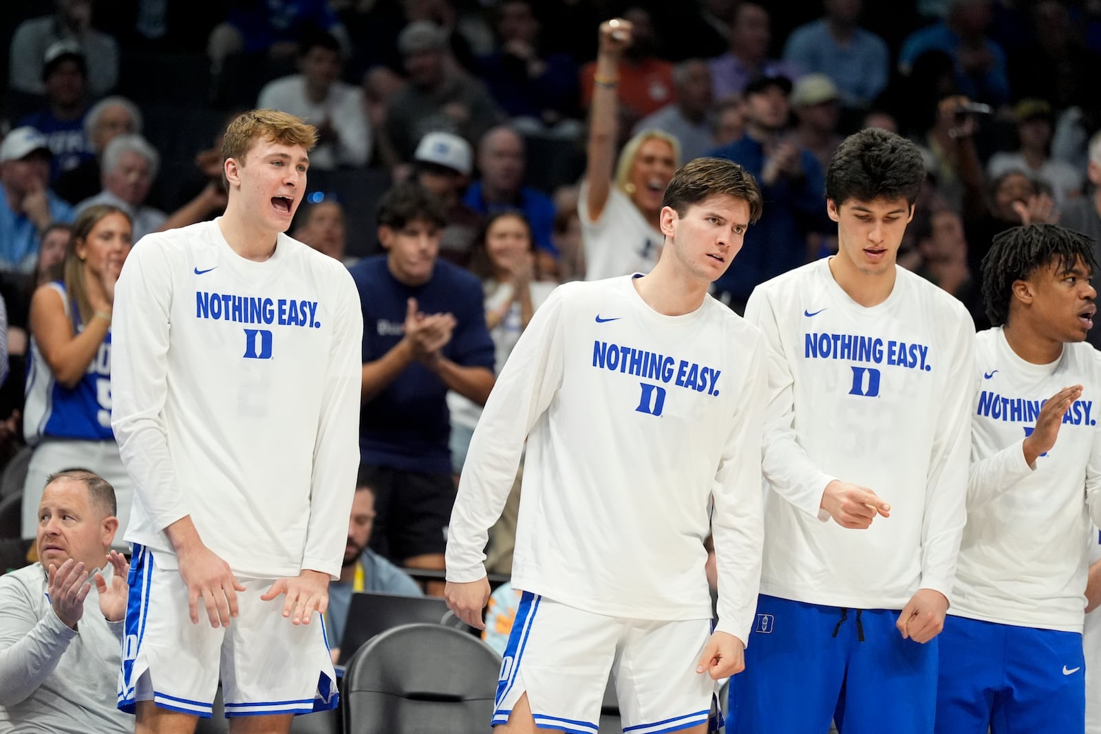 Duke forward Cooper Flagg, left, cheers from the bench during the second half of an NCAA college basketball game against Georgia Tech in the quarterfinals of the Atlantic Coast Conference tournament, Thursday, March 13, 2025, in Charlotte, N.C. Flagg was injured in the first half. (AP Photo/Chris Carlson)