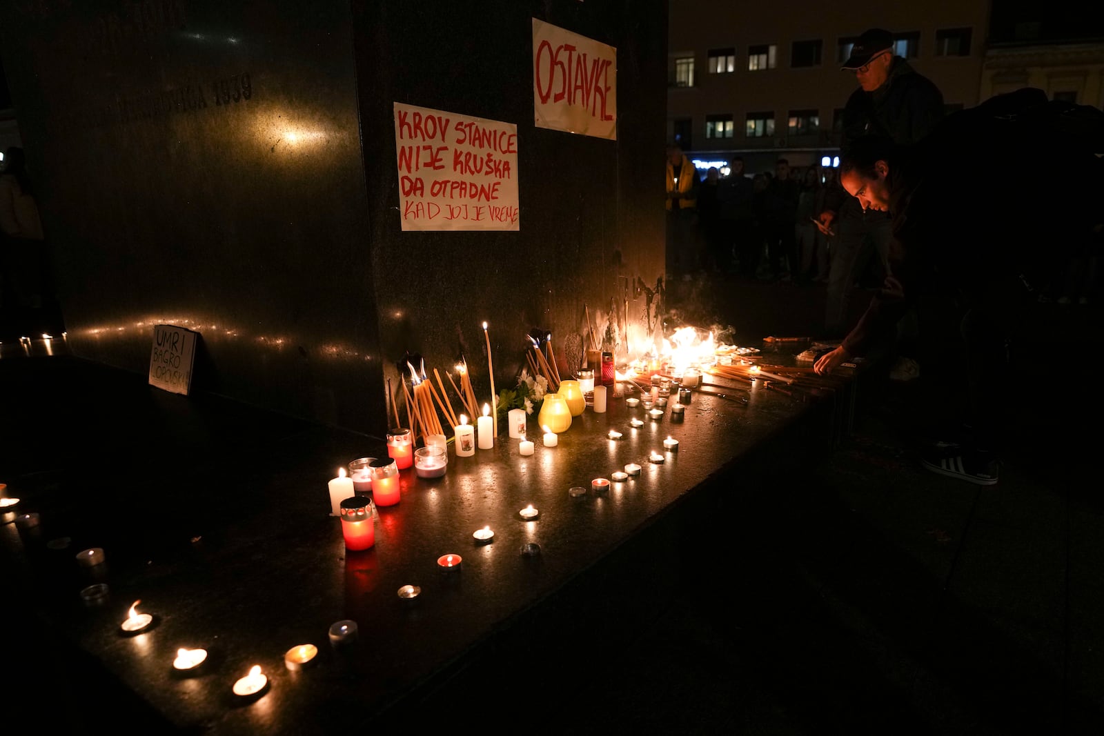 People light candles for the victims after an outdoor roof collapsed at a train station in Novi Sad, Serbia, Friday, Nov. 1, 2024. (AP Photo/Darko Vojinovic)