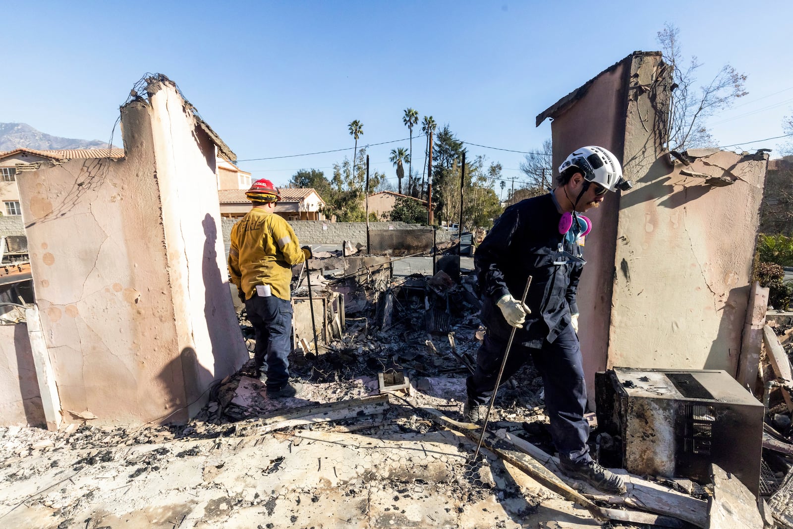 Search and Rescue crews work the devastation zone in the aftermath of the Eaton Fire Sunday, Jan. 12, 2025 in Altadena, Calif. (AP Photo/Ethan Swope)