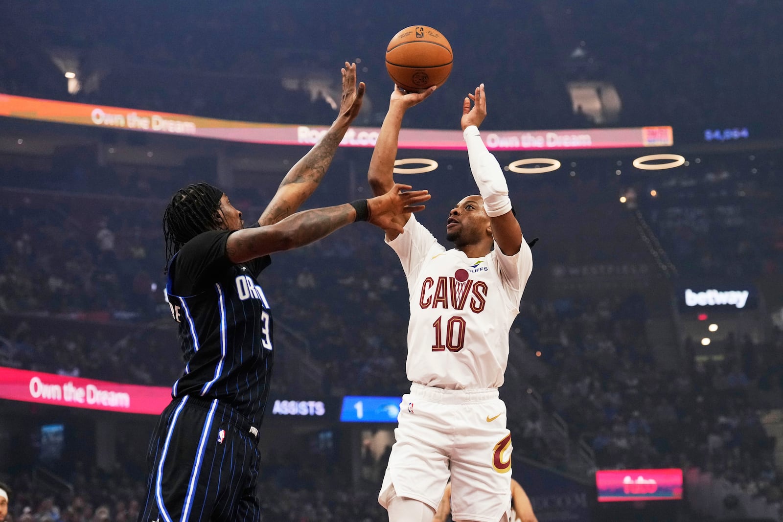 Cleveland Cavaliers guard Darius Garland (10) shoots as Orlando Magic guard Kentavious Caldwell-Pope, left, defends in the first half of an NBA basketball game Sunday, March 16, 2025, in Cleveland. (AP Photo/Sue Ogrocki)