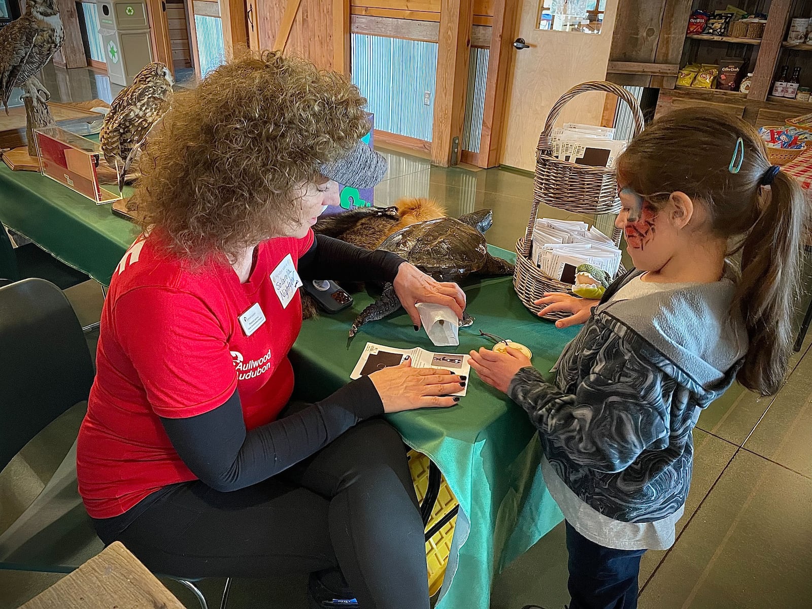 Wynter Weech, a 6-year-old from Sycamore, Illinois, makes Baily’s Beads at a total eclipse viewing event at Aullwood Audubon in Dayton on Monday, April 8, 2024. NATALIE JONES / STAFF