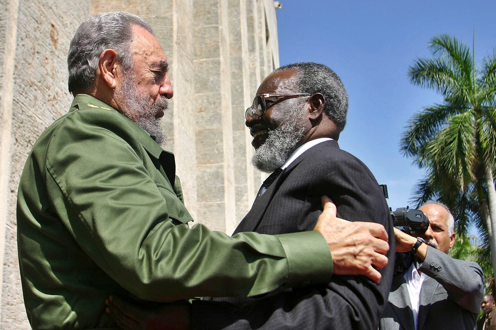 FILE - Cuban President Fidel Castro, left, hugs Namibian President Sam Nujoma during an official welcome ceremony in the state council in Havana, Cuba, June 23, 2004. (Sven Creutzmann/Pool Photo via AP, File)