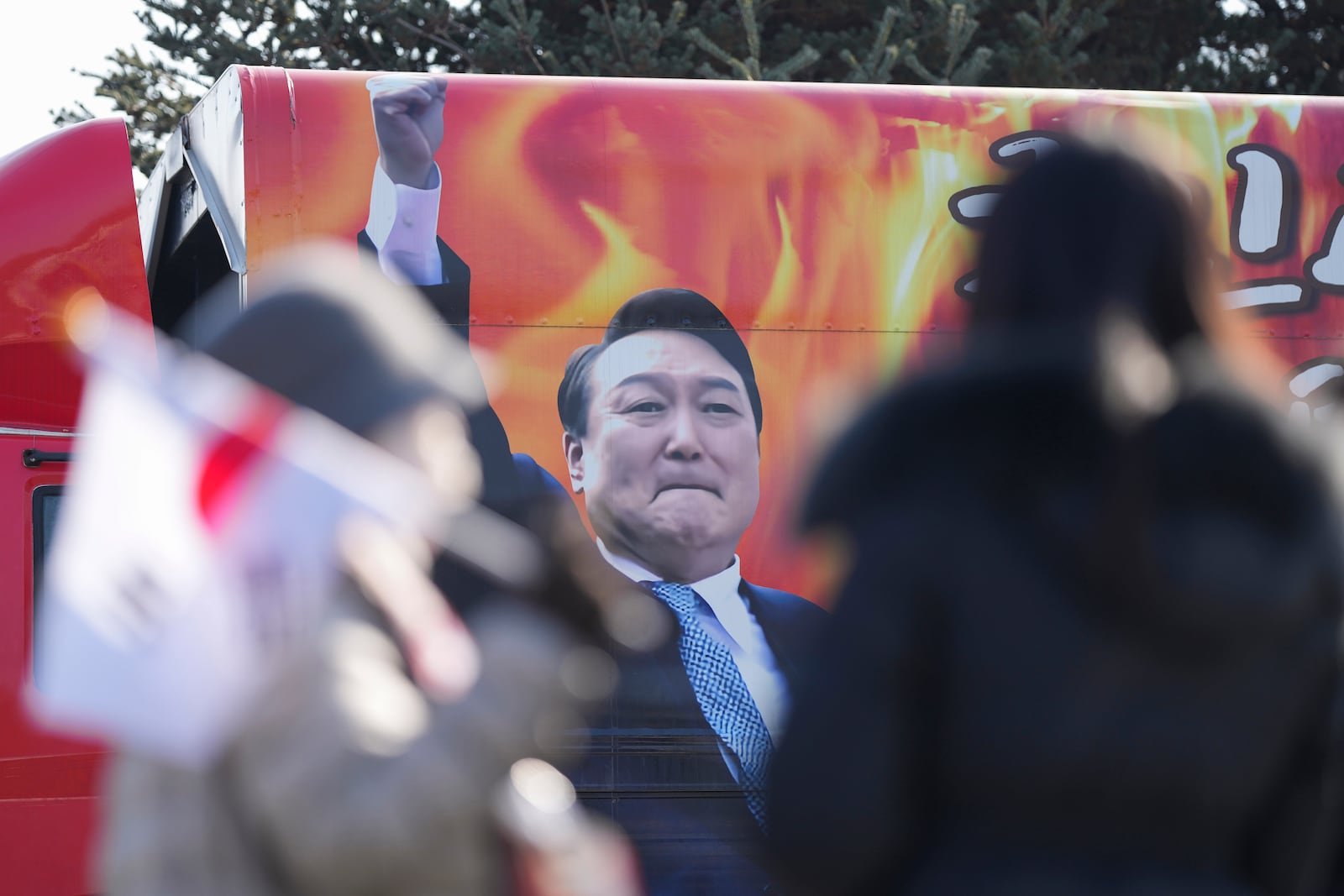 A picture of impeached South Korean President Yoon Suk Yeol is seen on the vehicle during a rally to oppose his impeachment outside of a detention center in Uiwang, South Korea, Friday, Jan. 17, 2025. (AP Photo/Lee Jin-man)