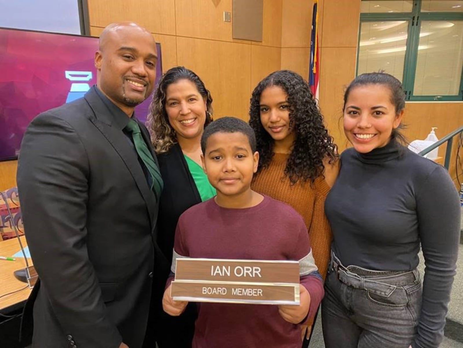 Newly sworn-in Mason Board of Education member Ian Orr, left, posed with members of his family after taking his seat on the board of Warren County's largest school system. Orr is the first African American to hold a seat on Mason's governing board in the district's history, which stretches back to the first half of the last century. (Provided Photo\Journal-News)