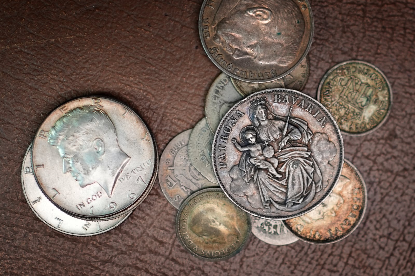 A collection of American and foreign coins await appraisal at Thomaston Place Auction Galleries, Tuesday, Nov. 19, 2024, in Thomaston, Maine. (AP Photo/Robert F. Bukaty)