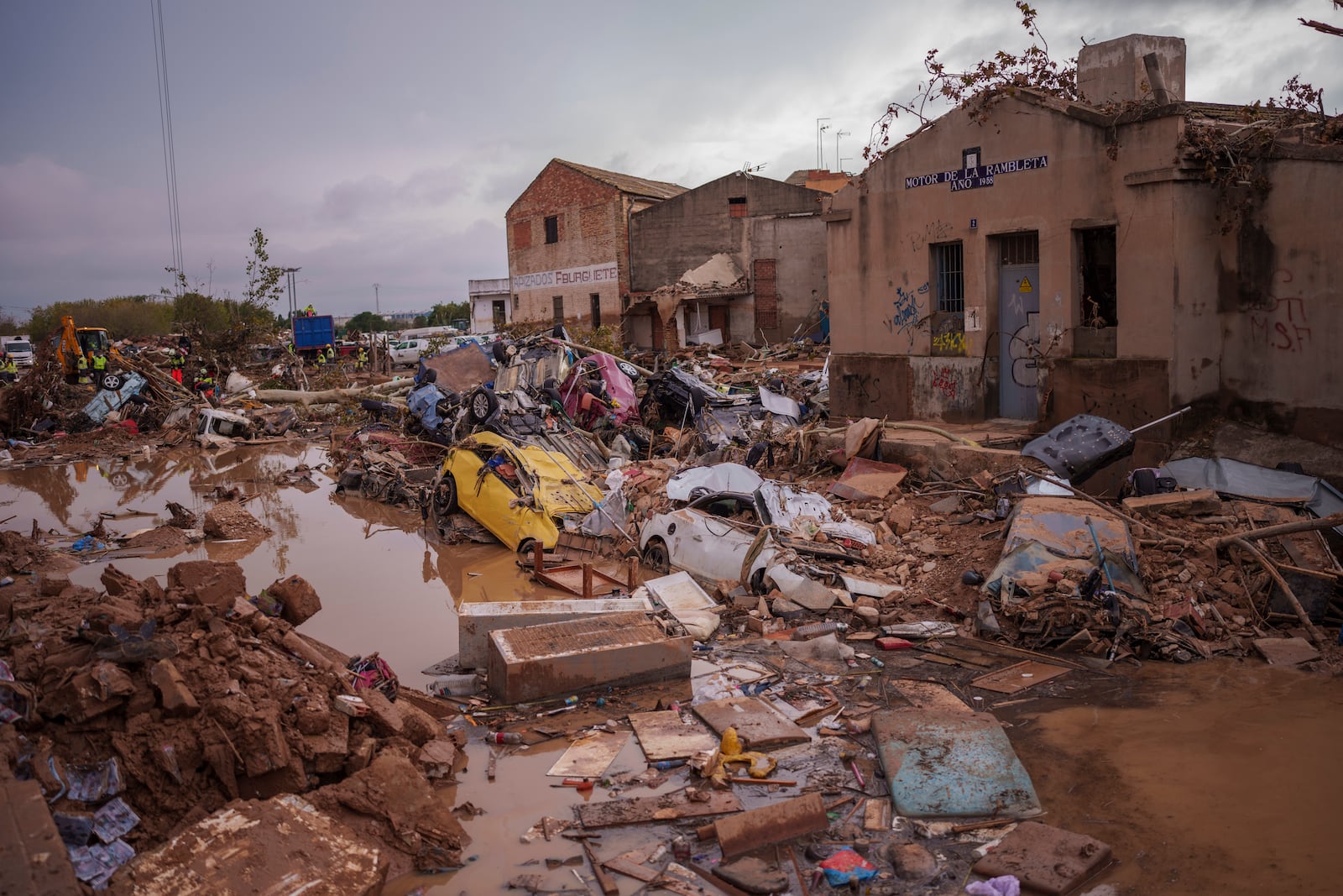 Vehicles trapped after the floods are pictured in an area affected by floods in Catarroja, Spain, Sunday, Nov. 3, 2024. (AP Photo/Manu Fernandez)