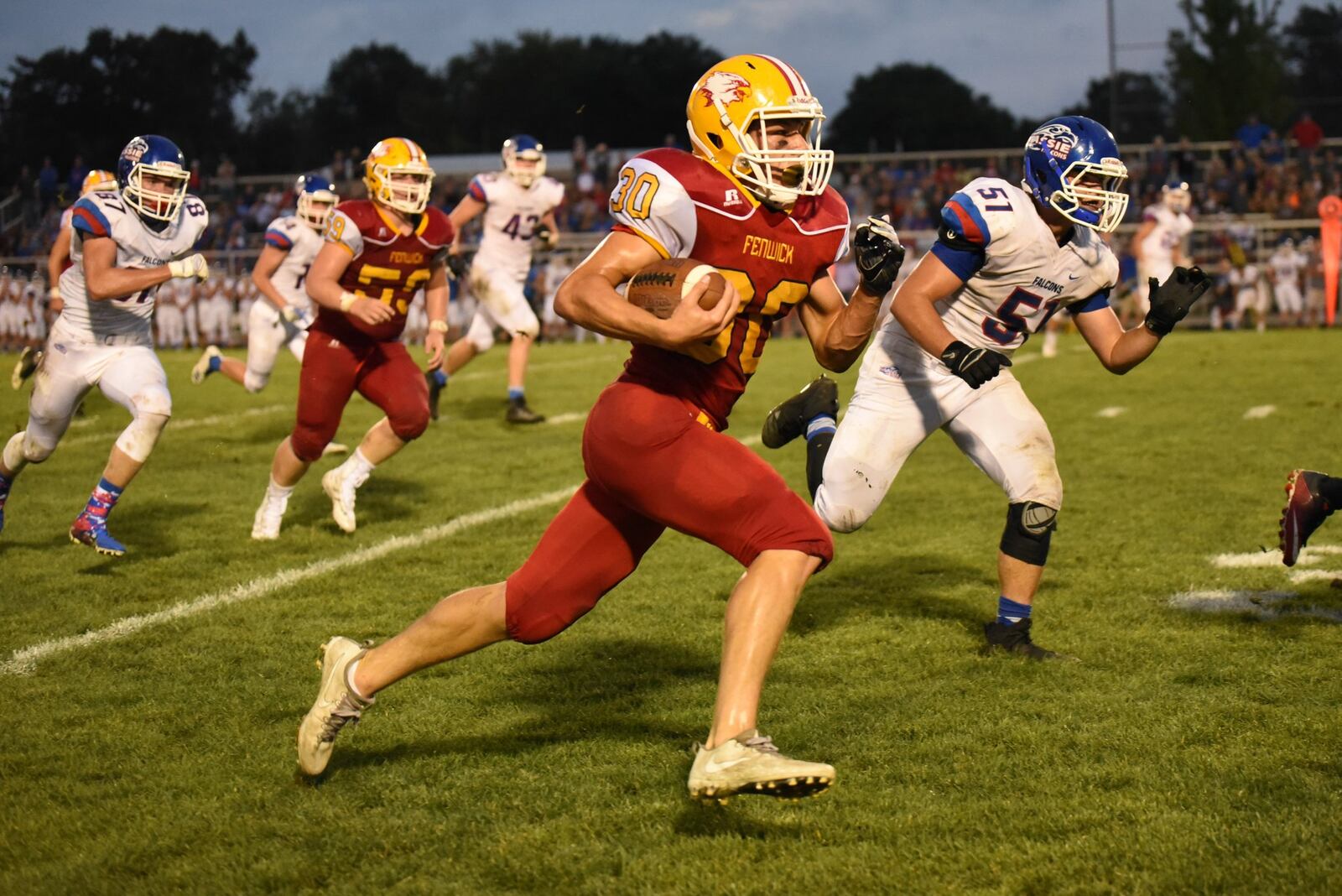 Fenwick’s Colt Bradshaw (30) sprints past Spencer Branham (51) of Clinton-Massie during Friday night’s game at Krusling Field in Middletown. Massie secured a 21-18 triumph. CONTRIBUTED PHOTO BY ANGIE MOHRHAUS