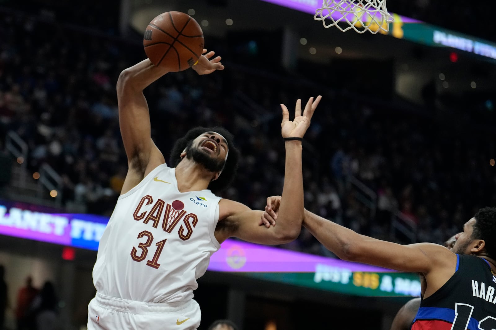 Cleveland Cavaliers center Jarrett Allen (31) is fouled by Detroit Pistons guard Ron Harper Jr., right, in the first half of an NBA basketball game, Monday, Jan. 27, 2025, in Cleveland. (AP Photo/Sue Ogrocki)