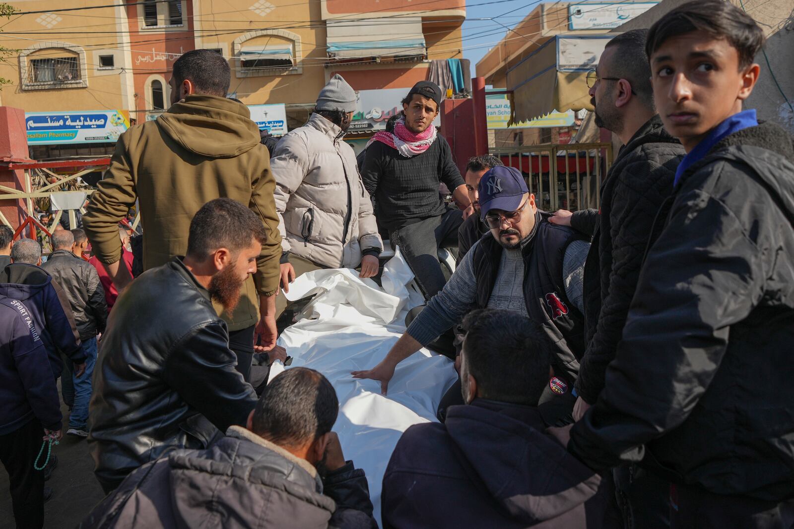 The bodies of civilian victims of an overnight Israeli army airstrike on the Nuseirat refugee camp arrive at the Al-Aqsa Martyrs hospital in Deir al-Balah, Gaza Strip, Thursday Dec. 12, 2024. Palestinian medical officials say Israeli airstrikes have killed at least 28 people in the Gaza Strip, including seven children and a woman. (AP Photo/Abdel Kareem Hana)