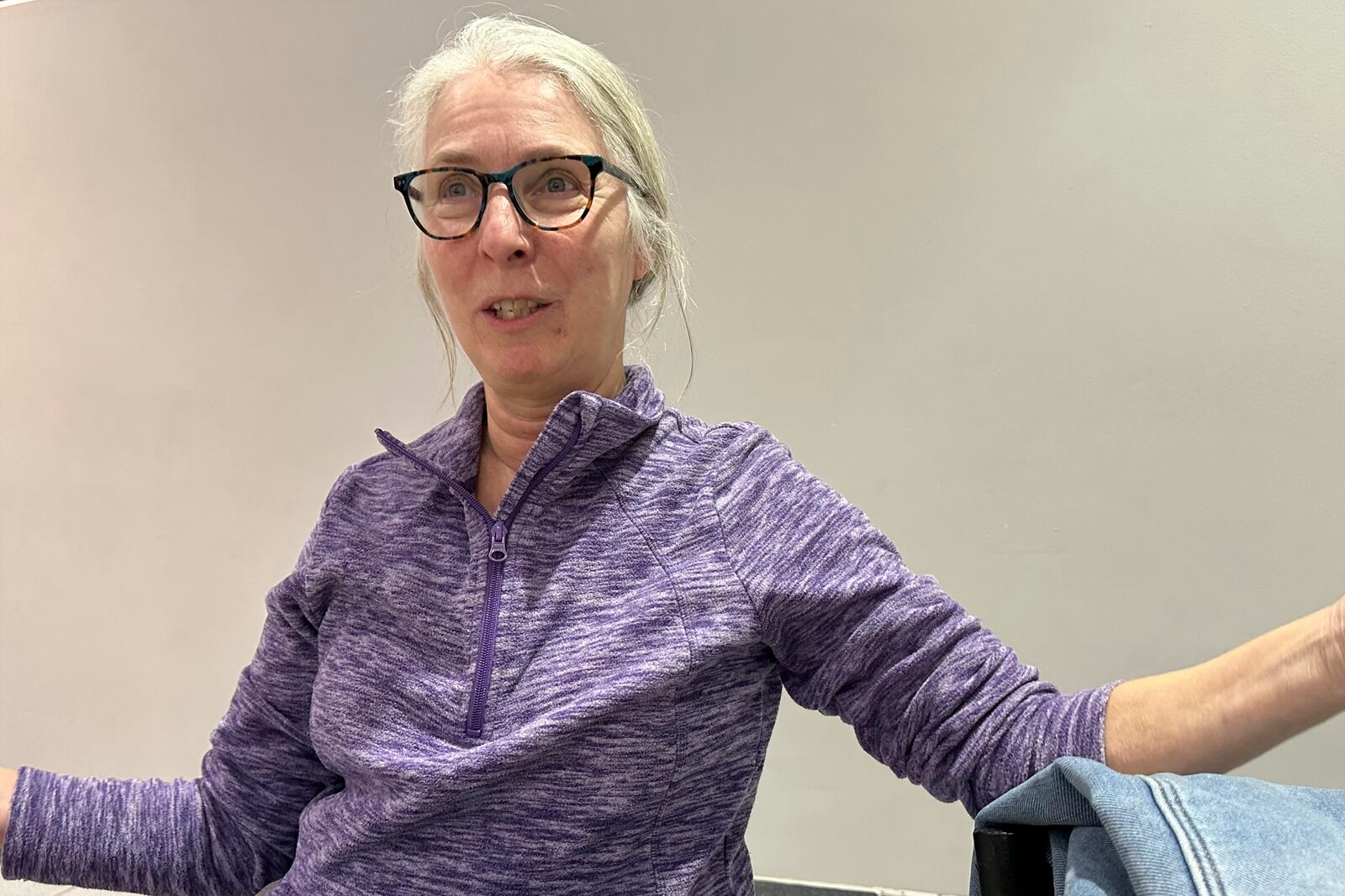 Becky Olsen, 66, is a retired teacher and administrator for deaf education who opposes Elon Musk's effort to sharply cut the federal workforce, talks Feb. 5, 2025, in Urbandale, Iowa. (AP Photo/Thomas Beaumont)