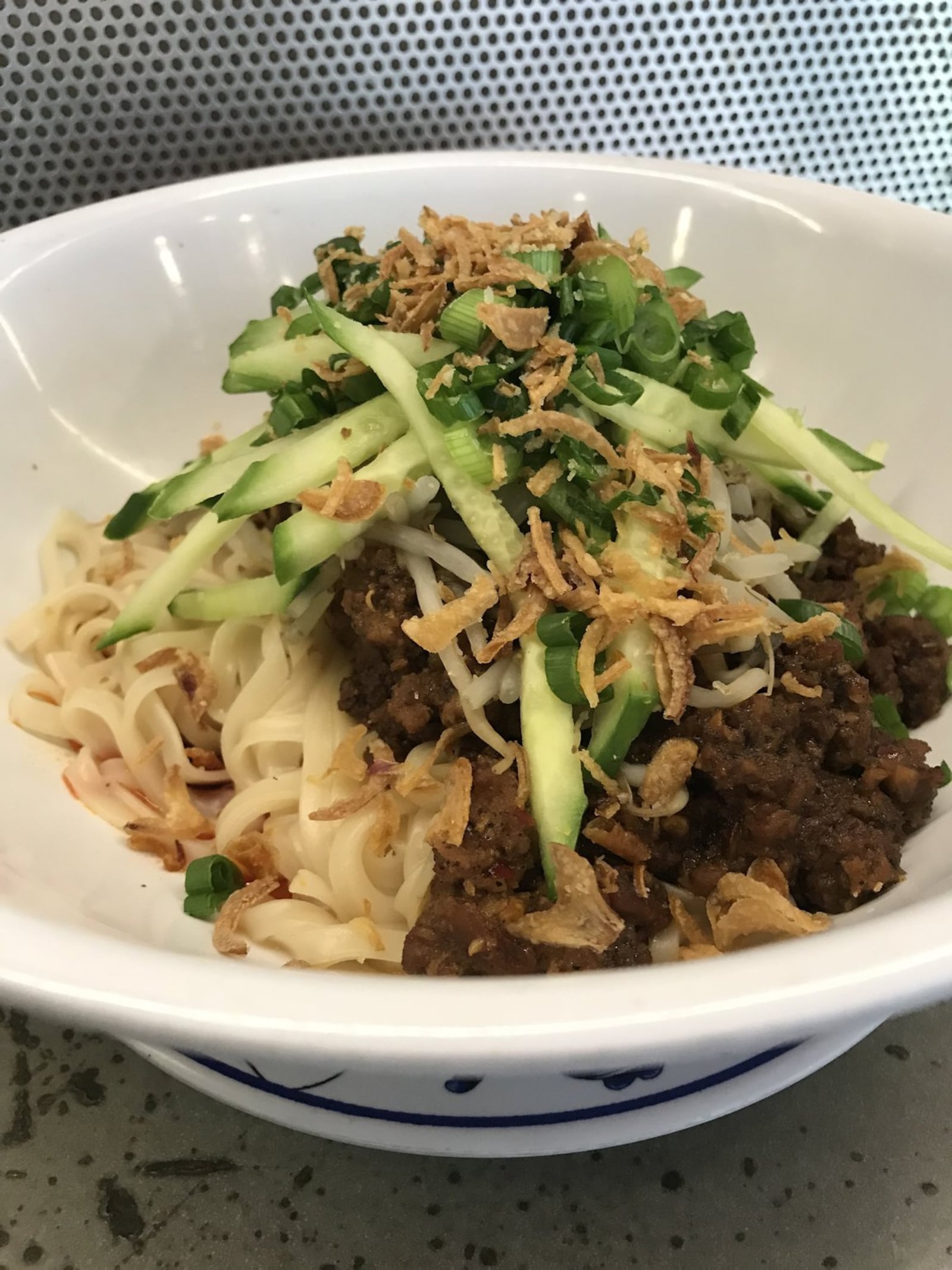 The Lang Thang Group’s Spicy Sichuan Five-Way consists of Dandan noodles, chili, and marinated pork, piled high with various seasonings and toppings. CONTRIBUTED