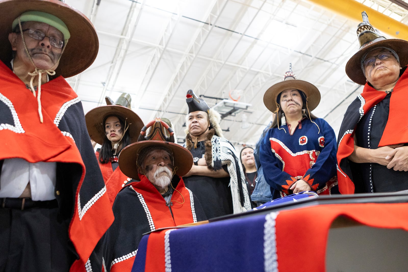 Tlingit clan members from Angoon, Alaska, await a formal apology during a U.S. Navy ceremony Saturday, Oct. 26, 2024, in Angoon, Alaska, for the 1882 military bombing on the Tlingit village in Angoon. (Nobu Koch/Sealaska Heritage Institute via AP)