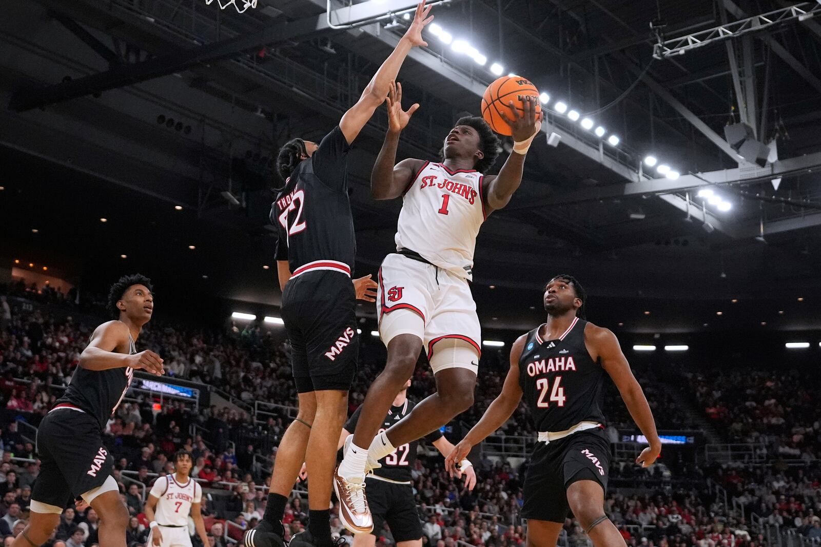 St. John's guard Kadary Richmond (1) drives to the basket against Omaha during the first half in the first round of the NCAA college basketball tournament, Thursday, March 20, 2025, in Providence, R.I. (AP Photo/Charles Krupa)