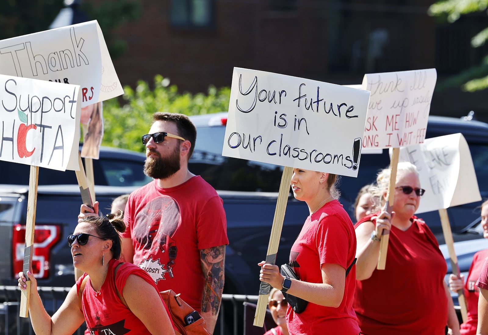 Hamilton teachers gathered along Dayton Street in front of the Hamilton City School District building to demonstrate for fair pay for teachers Wednesday, June 22, 2022. NICK GRAHAM/STAFF