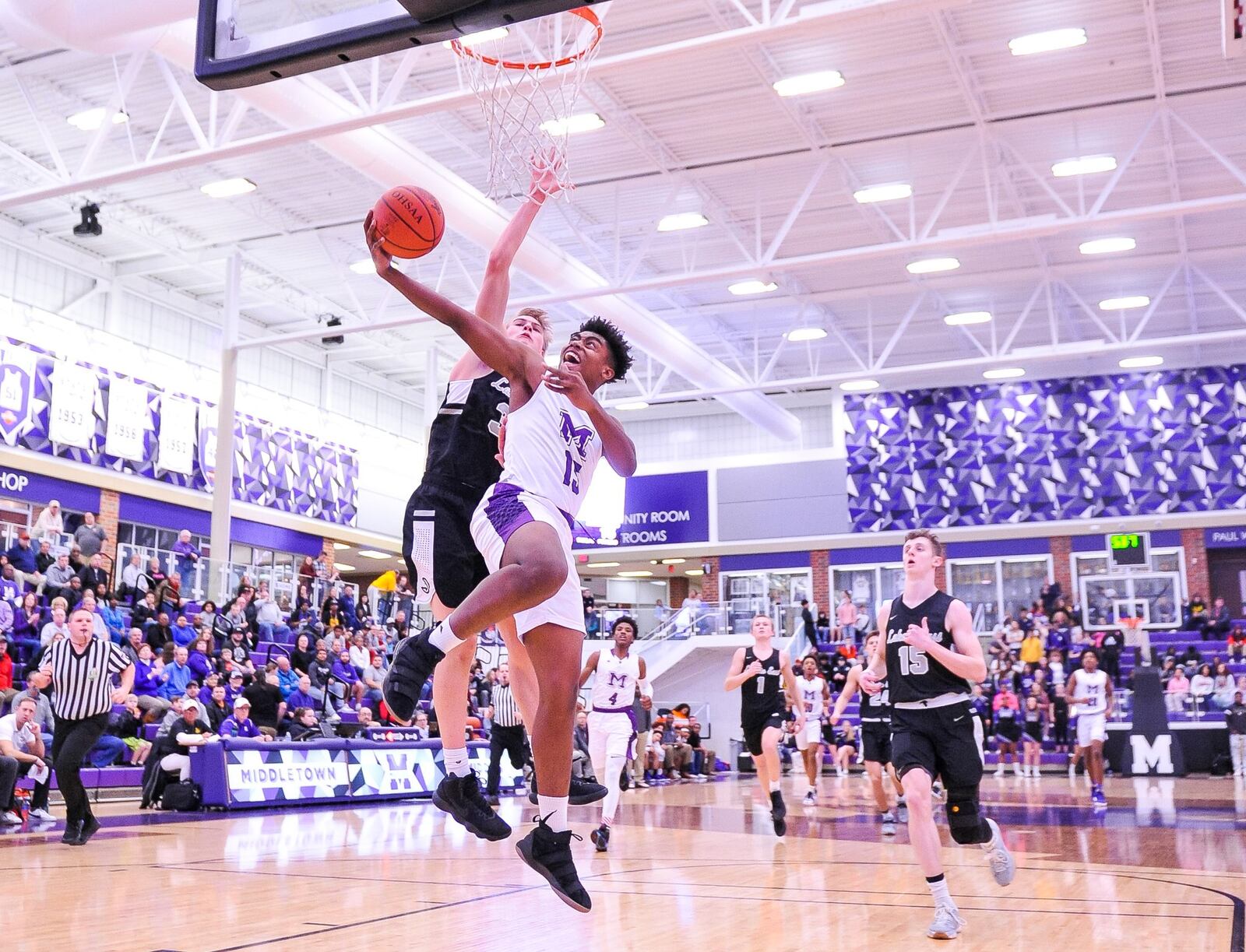 Middletown’s Chance Walker goes to the hoop as Lakota East’s Grant Spicer provides the defense during Tuesday night’s game at Wade E. Miller Arena in Middletown. East won 61-47. NICK GRAHAM/STAFF