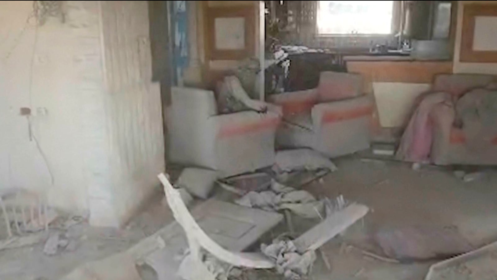 This video grab released by the Israeli military on Thursday Oct. 17, 2024, shows a destroyed building, with a person the Israeli military identified as Hamas leader Yahya Sinwar seated in chair. (IDF via AP)