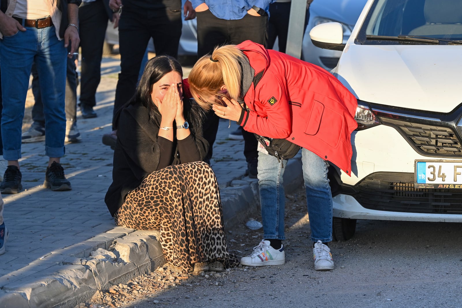 People gather outside of Turkish Aerospace Industries Inc. at the outskirts of Ankara, Turkey, Wednesday, Oct. 23, 2024. (AP Photo/Mert Gokhan Koc)