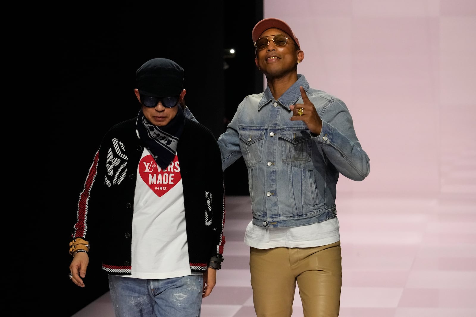 Pharrell Williams, right, walks with with Nigo, artistic designer for Kenzo, with who co-creates a collection, after the men's Louis Vuitton Fall-Winter 2025-2026 collection, that was presented in Paris, Tuesday, Jan. 21, 2025. (AP Photo/Michel Euler)