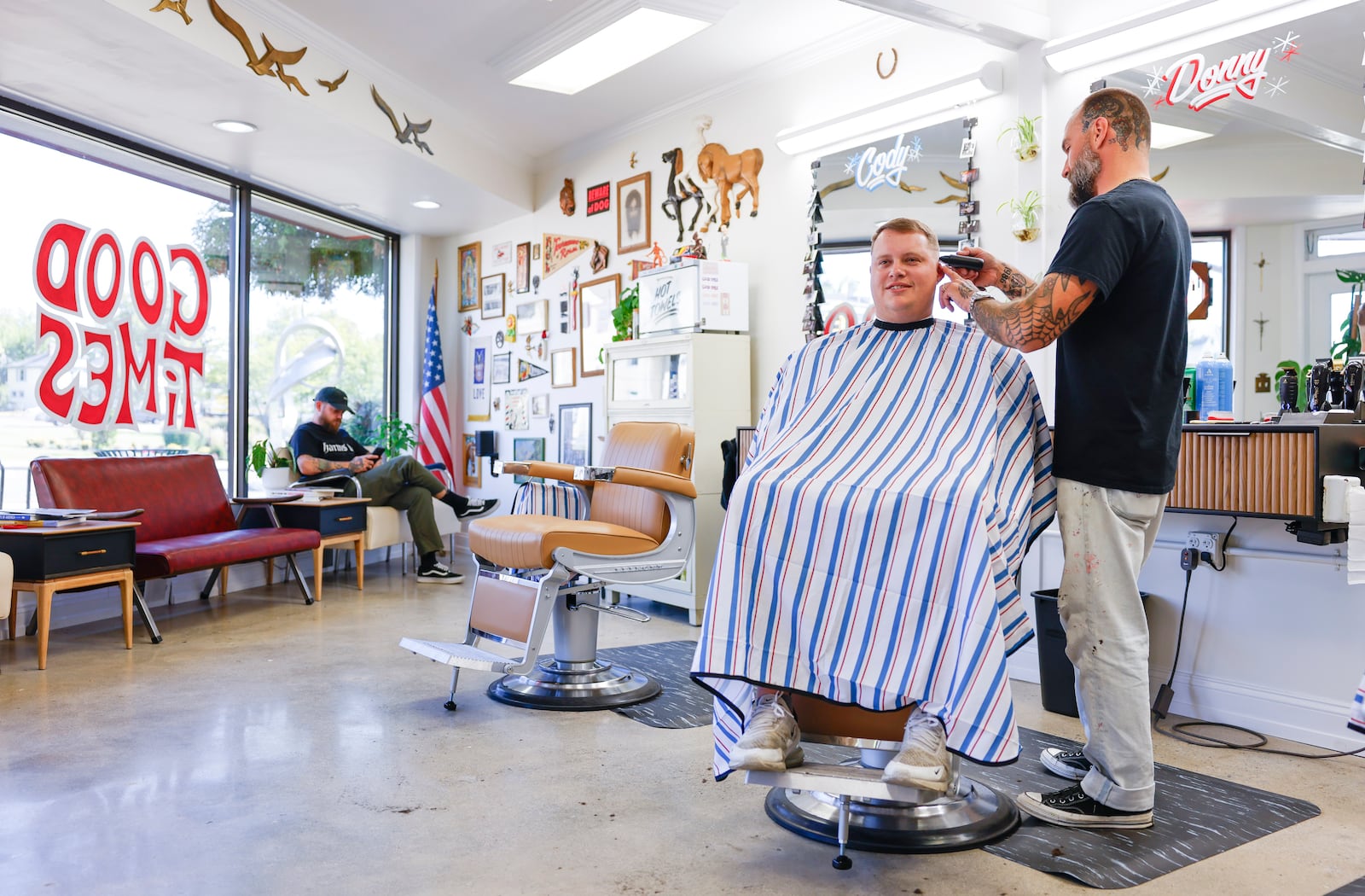 Donny Delph cuts Josh Abner's hair at the new Good Times barber shop at 10 Millville Avenue at corner of Millville and Main Street in Hamilton. NICK GRAHAM/STAFF