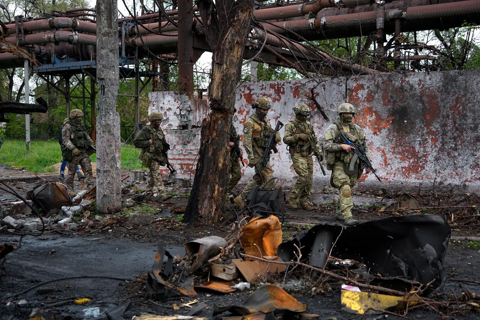 FILE - Russian troops walk in a destroyed part of the Illich Iron & Steel Works Metallurgical Plant in the city of Mariupol in the Donetsk region of eastern Ukraine, on May 18, 2022. (AP Photo, File)