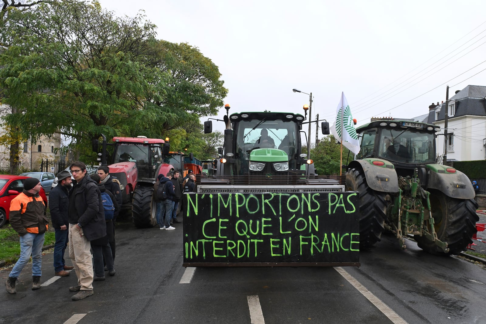 Farmers gather by their tractors before a rally against the EU-Mercosur trade agreement, Monday, Nov. 18, 2024 in Beauvais, northern France. Poster reads: do not import what is is forbidden in France. (AP Photo/Matthieu Mirville)